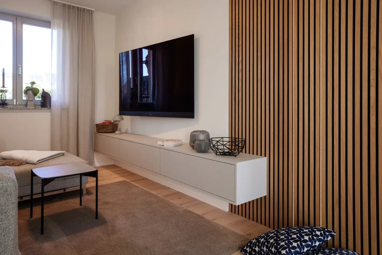 Sideboard mit Lamellen-Front als Raumteiler im Wartebereich